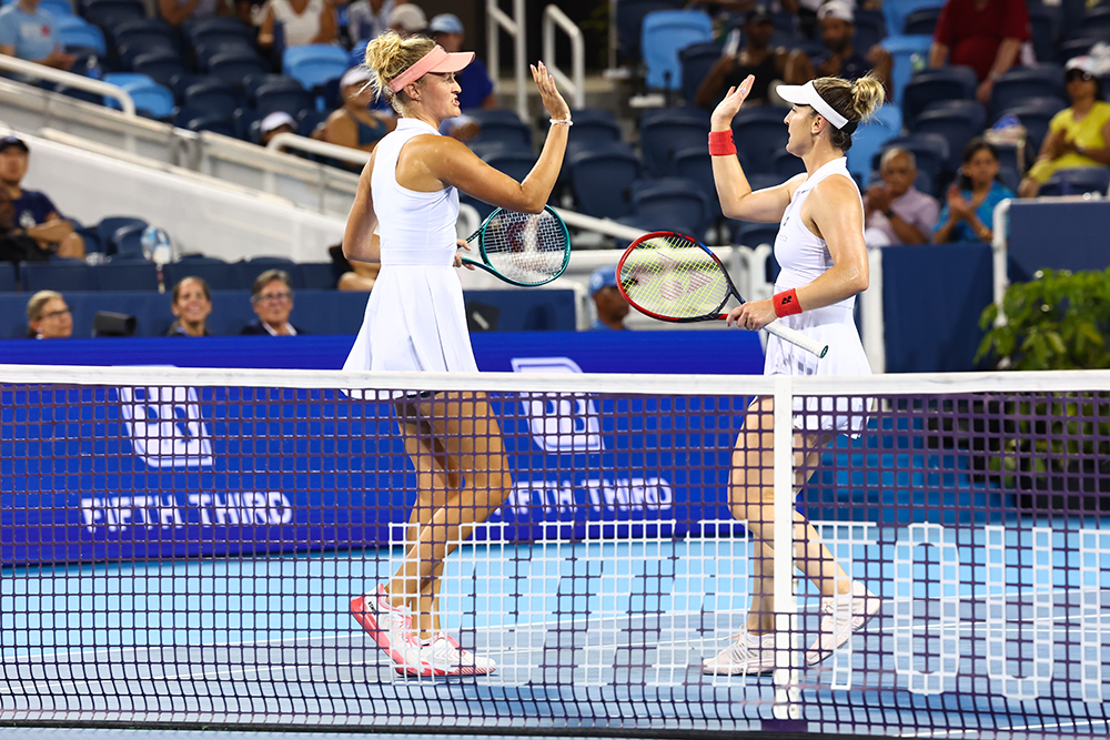 image of two tennis players high-fiving